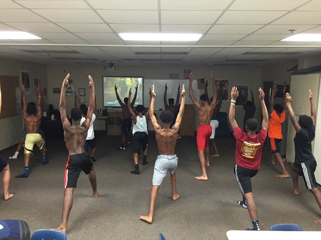 Athletes stretching in a training room