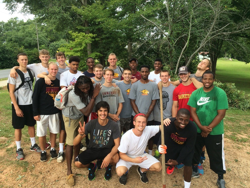 Basketball team serving the community outdoors