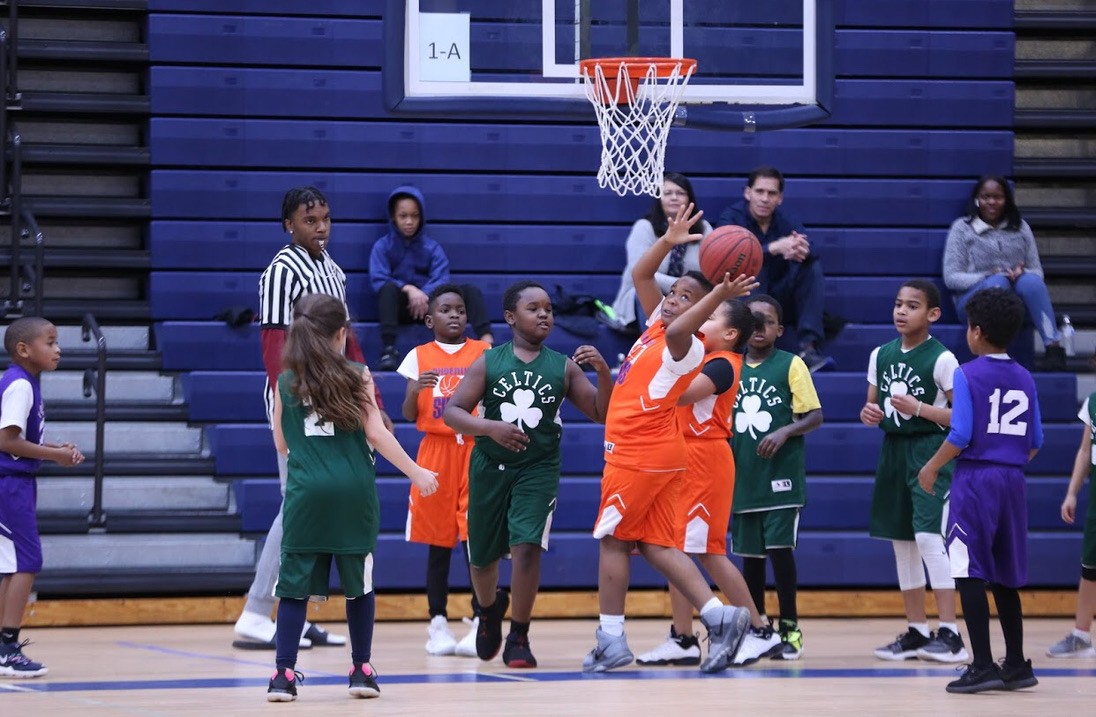 Young players competing near the basket