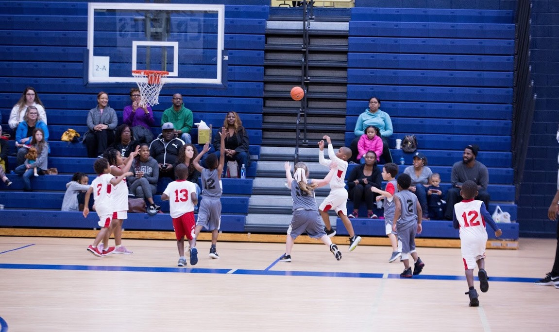 Youth basketball players competing in a gym